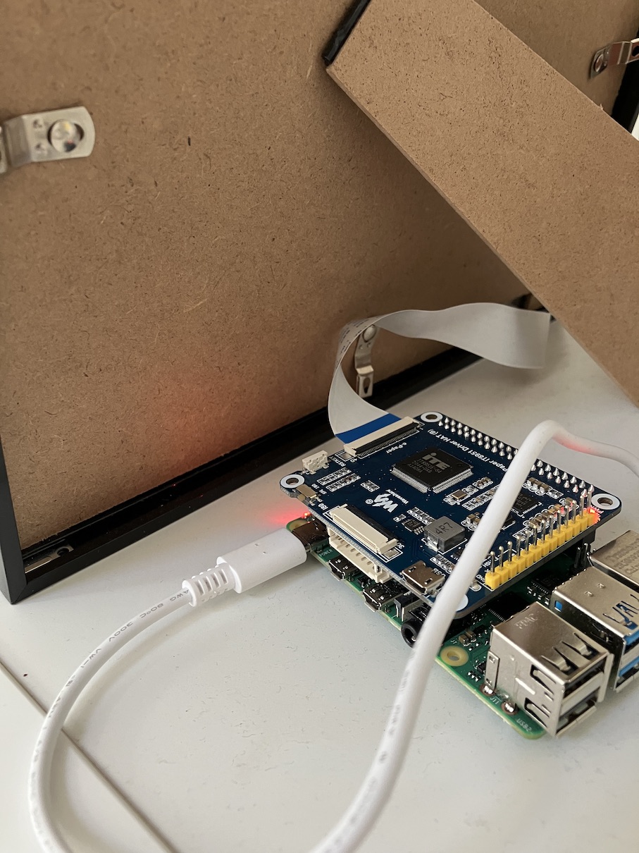 The back of Very Slow Movie Player showing a picture frame, and a Raspberry Pi